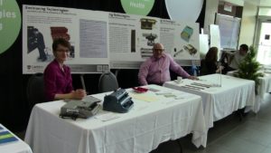 Beth displaying the "Envisioning Technologies" exhibit at Carleton University Life Science Day with colleague and Social Worker Roy Hanes.